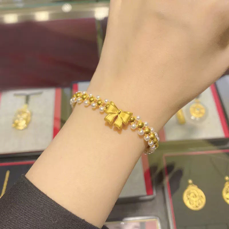 黄金在逃公主蝴蝶结手链女999足金转运珠淡水珍珠手串编织手绳饰