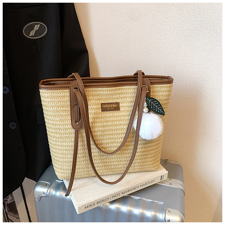 This is a new 2025 summer beach-style women's bag with a simple and versatile hand-held design. It's a single-shoulder vacation woven bag undefined