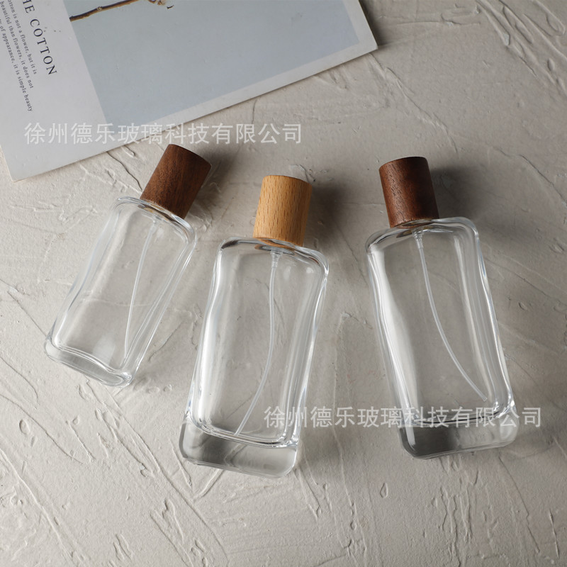 Wholesale 30ml50ml100ml wooden cap perfume bottle transparent glass cosmetic sub-packing bayonet crimp spray bottle
