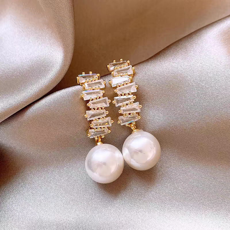 Fashionable small earrings from pearl with zircon