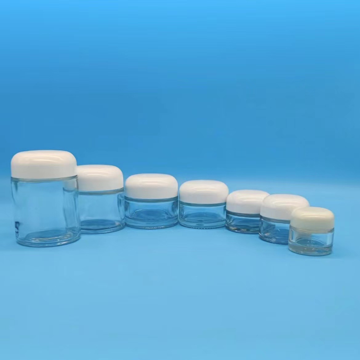 Ventas directas de fábrica 15-100g botella de ungüento de boca ancha transparente cúpula botella de crema cosmética botella de crema de vidrio 50g