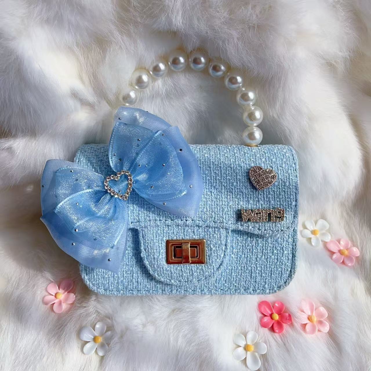 2025 nuevo arco bolsos para niños pequeños perlas de moda accesorios bolsos de cambio princesa bolsos de mano diagonales