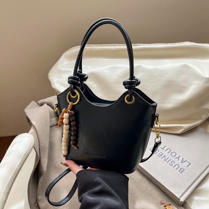 Coreano retro cuero suave bolso de cubo de mano 2025 nuevo estilo de alto nivel bolso de hombro de moda bolso de viaje para mujeres