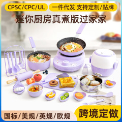 子供のミニの小さい台所のおもちゃの女の子は料理をします。