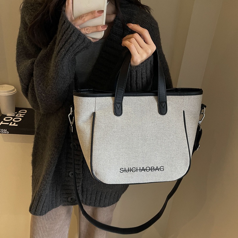 Estilo coreano de moda de contraste de color lienzo bolsa de mano portátil para las mujeres 2023 transfronteriza nueva textura de alto grado de hombro bolsa de mensajero