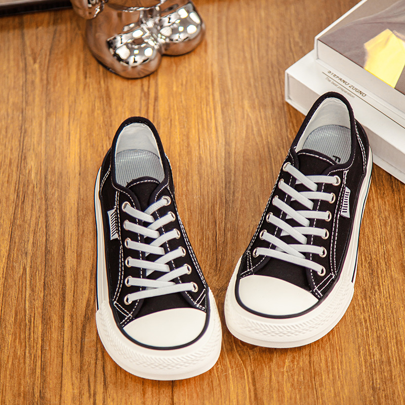 2026 primavera y verano nuevos zapatos de lona de mujer de altura baja con suela gruesa delantera correa de abertura superficial zapatos de lona casuales de estudiantes