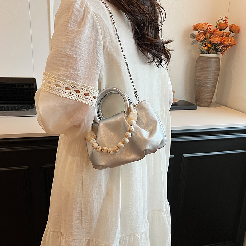 High end handbag for women in 2024, new niche design, summer handheld pleated chain strap, crossbody cloud bag_voghion.com