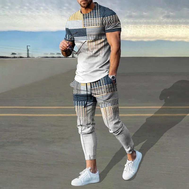 男性のスーツの夏の青年の半袖のtシャツのストライプは色のゆったりした弾力の薄い運動のズボンの2つのセットをつづり合わせます。|undefined