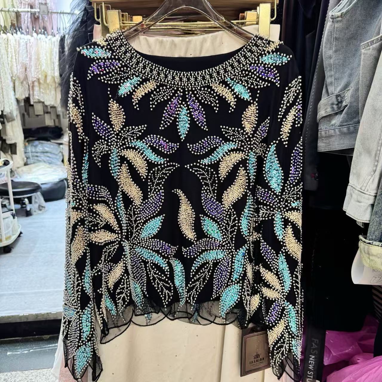 Real shot of a cross-border heavy-duty light luxury lace blouse for women, sequined and beaded design, long-sleeved, versatile, loose and chic top.