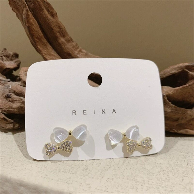Серебряная игла, цирконий, дизайнерские универсальные красивые серьги с бантом, образец серебра 925, микрореставрация, кото-глаз, стиль лёгкой роскоши, тренд сезона