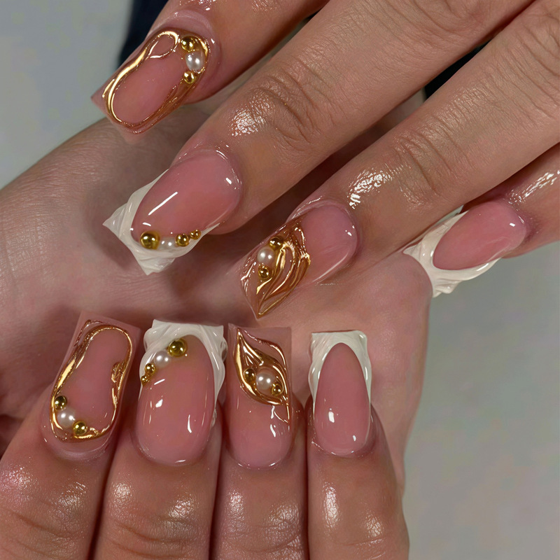 3D three-dimensional pearl manicure in nude pink base color, simple and elegant design with gold accents, French-style false nails wholesale