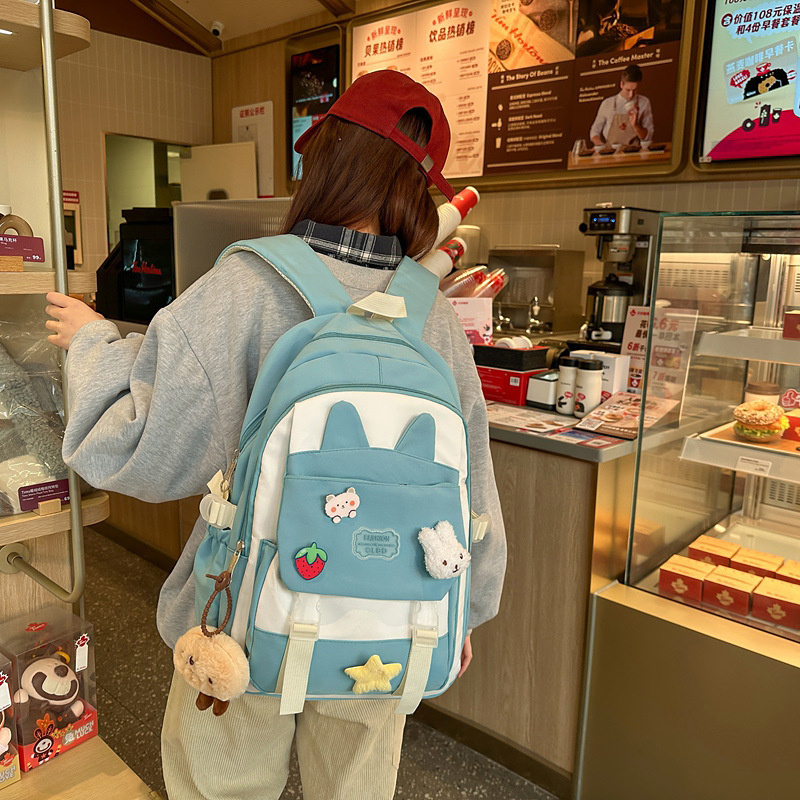 La versión coreana de las mochilas escolares de doble hombro está llena de mochilas escolares de primaria y mochilas escolares de tendencia de la escuela secundaria de gran capacidad.