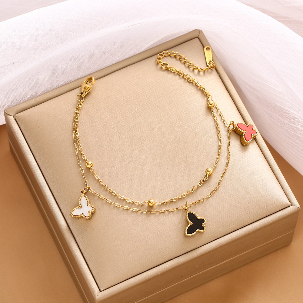 Pulsera de trébol de acero titanium vendedora caliente transfronteriza europea y americana con incrustaciones de concha pulsera colgante pulsera de diseño avanzado sin desvanecimiento al por mayor