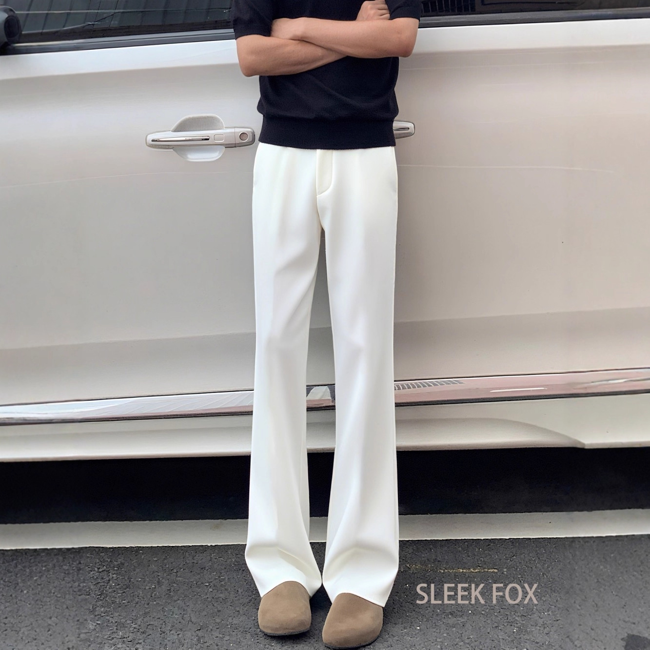 Men's black curved trousers with a flowing drape, trendy and luxurious design, slightly flared, versatile for autumn, flattering and casual.