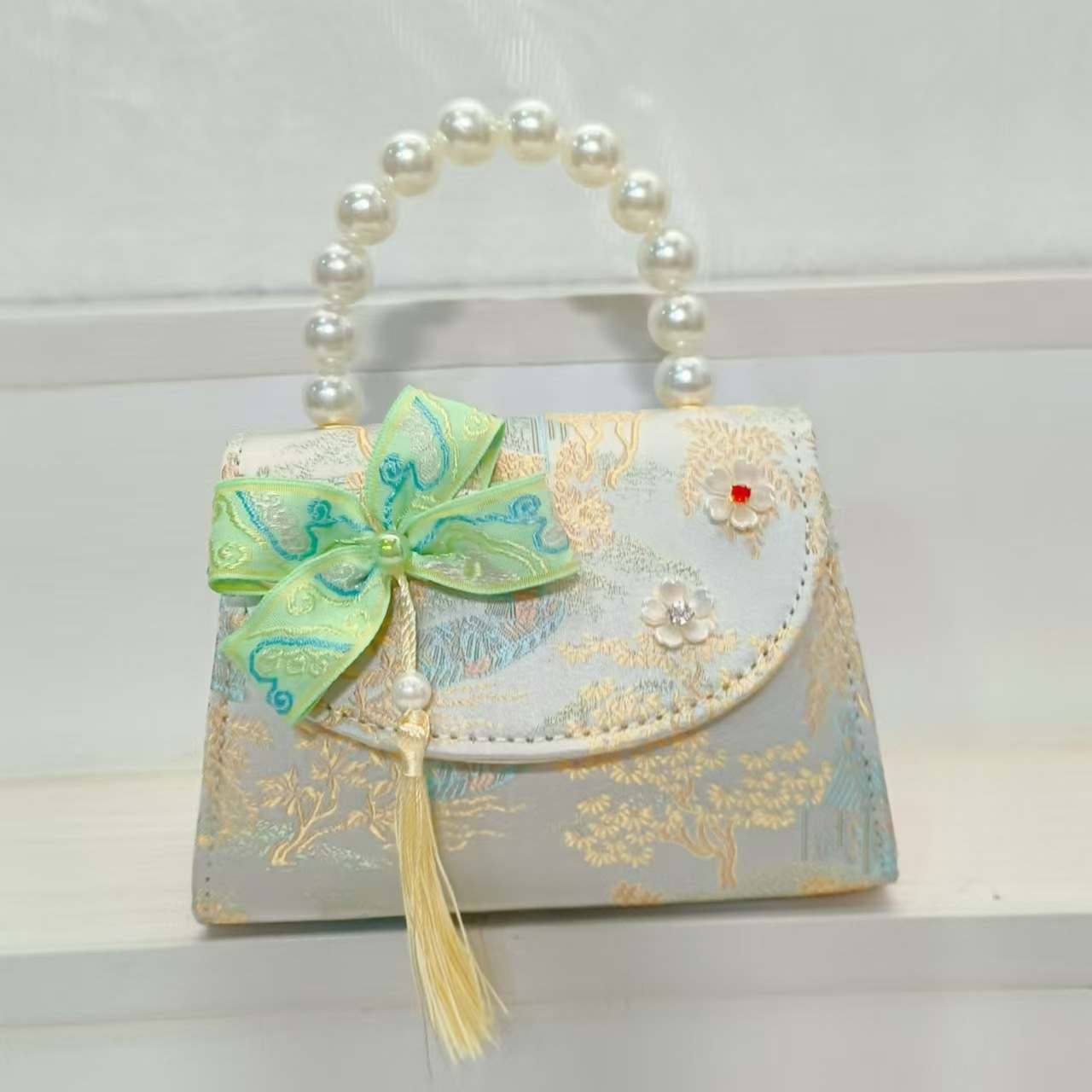 Bolsas de niños arco de estilo chino borda de niña pequeña princesa perla bolsa de cambio de mano al por mayor