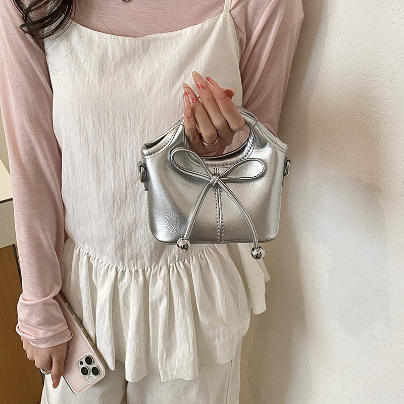Bolsas infantiles transfronterizas de moda coreana de color sólido, bolsas de mano de chicas, mini bolsas de cestas de arco lindas