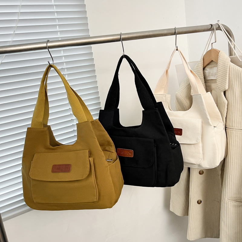 2024 invierno nuevo paquete de viaje japonés retro nicho sensación de diseño bolso de lona simple color sólido bolso casual