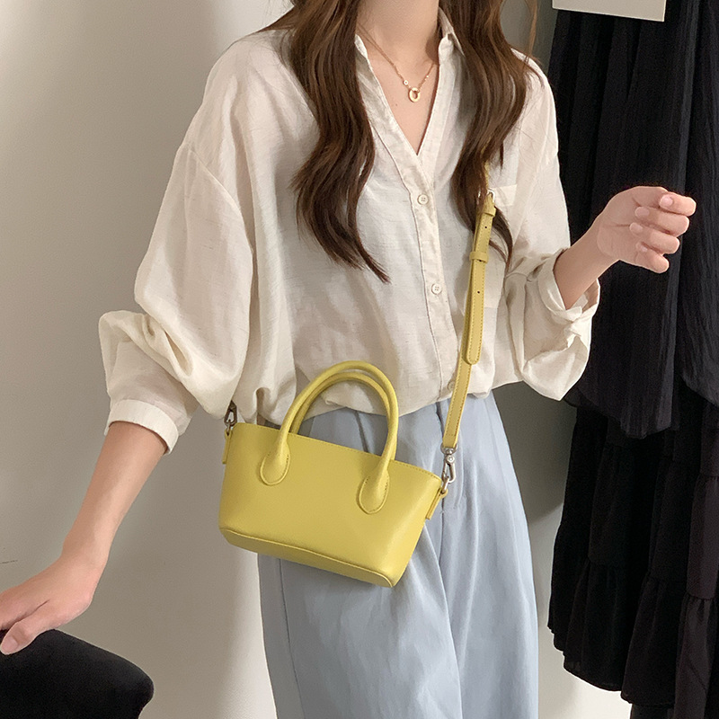 Mini bolsa de cesta de verduras de cuero minimalista 2025 nuevo estilo de piel de vaca Xiaozhong lingote bolso de mensajero portátil bolso de hombro femenino