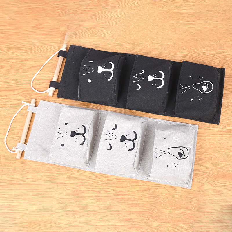 Suministro de algodón y lino de dibujos animados expresión de tres bolsillos de una pieza de almacenamiento bolsa colgante semicírculo bolsa colgante decorativa bolsa colgante