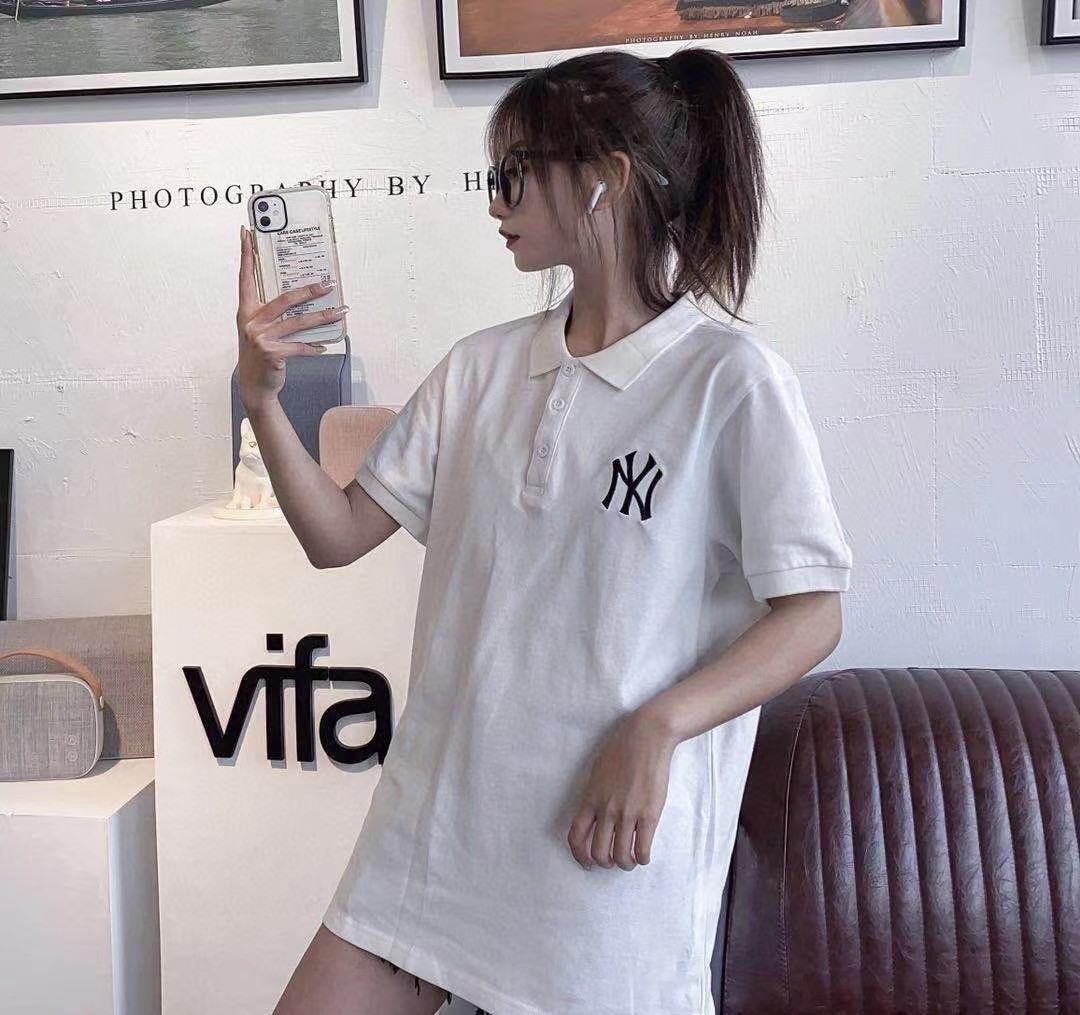 Couple Wearing Yankees Polo Shirt