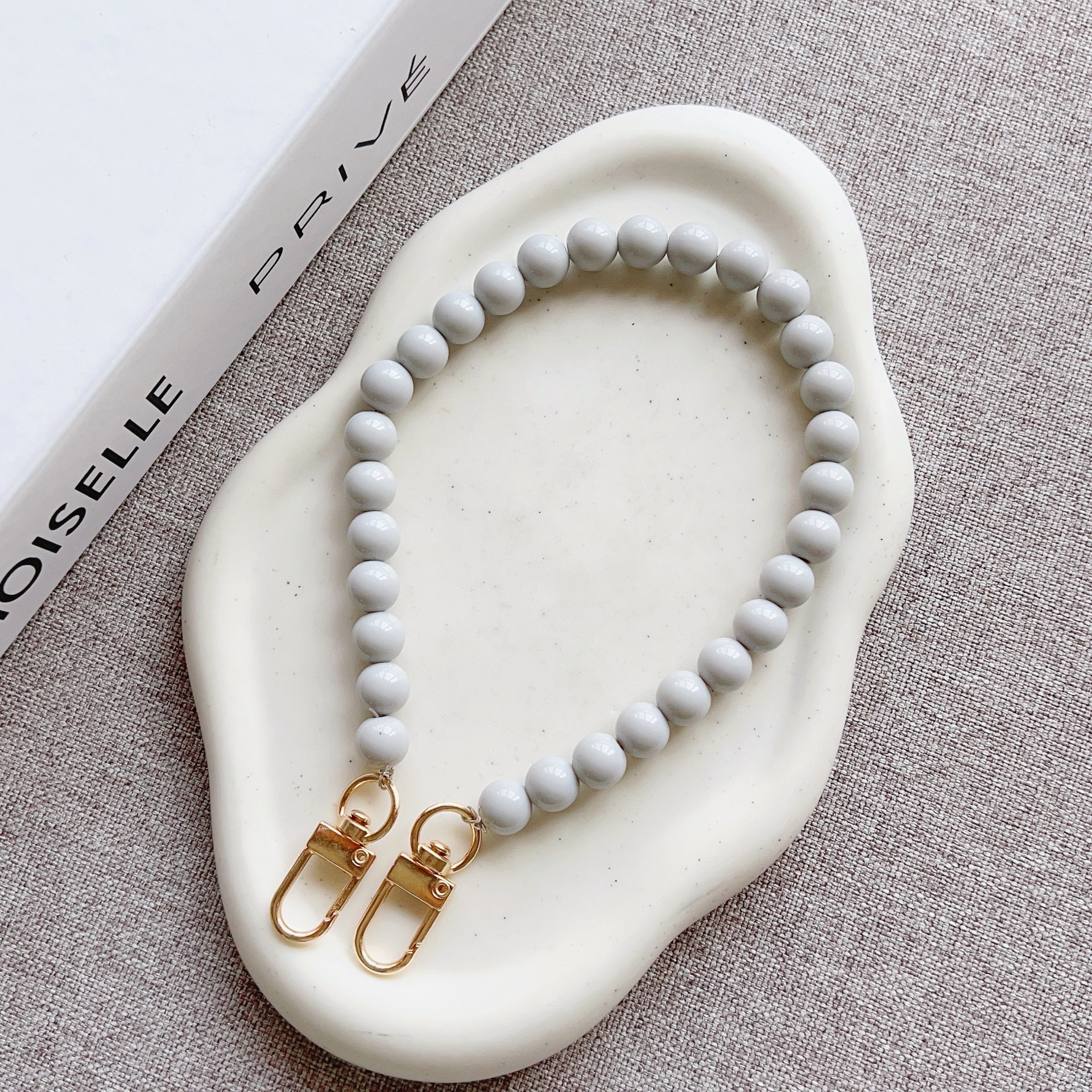 Nuevo estilo japonés y coreano cadena de cuentas de color sólido pulsera corta llavero bolsa de accesorios de cadena de perlas de todo fósforo cordón transfronterizo