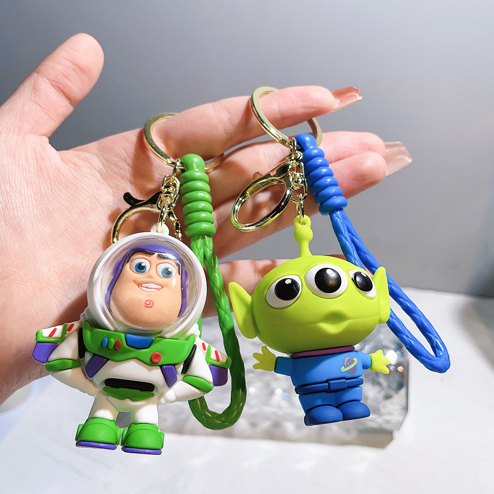 Llavero de silicona de Toy Story, el popular dibujo animado, con personajes como el alienígena de tres ojos, Buzz Lightyear y el oso Lotso, ideal como adorno para bolso.