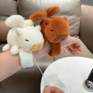 Мягкая игрушка капибара с крыльями на запястье