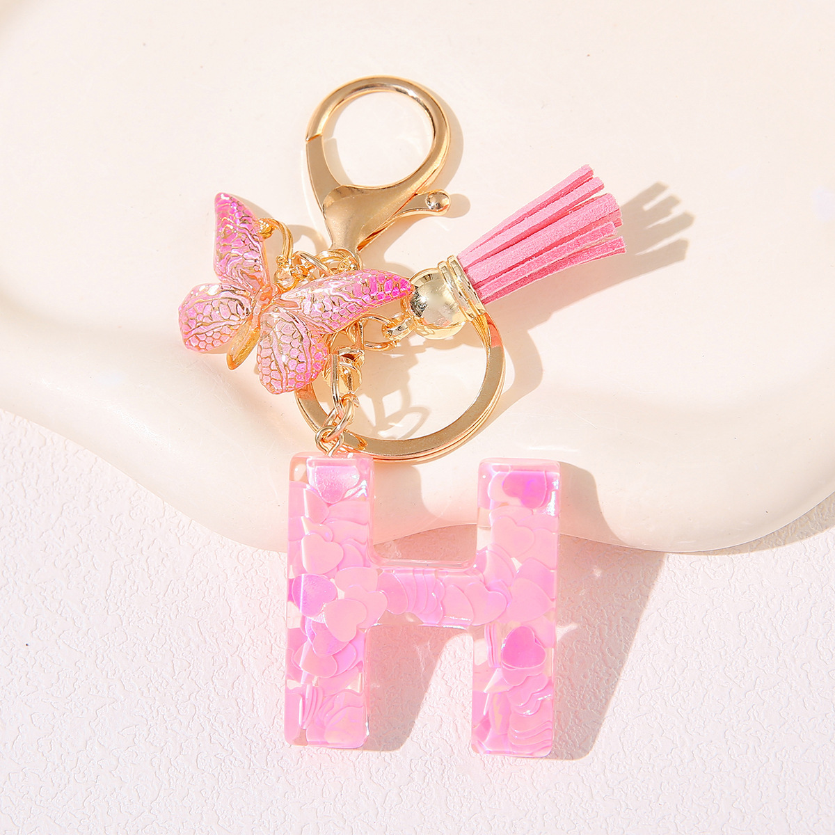 Nuevo rosa damas letras A-Z llavero de goteo de goma sequilla amor letras bordas mariposa llavero transfronterizo