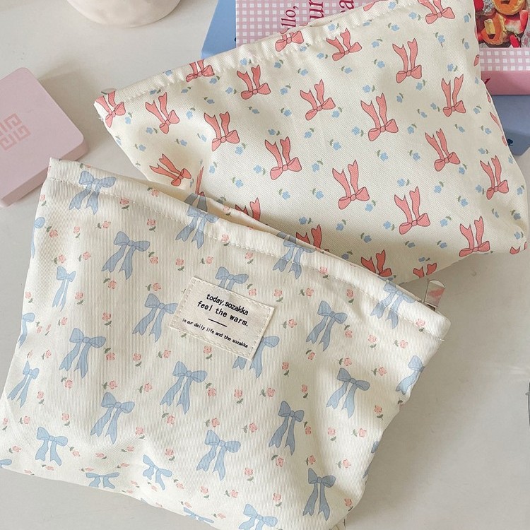Cosmetic bag with bow, handheld storage system, cloth, wallet