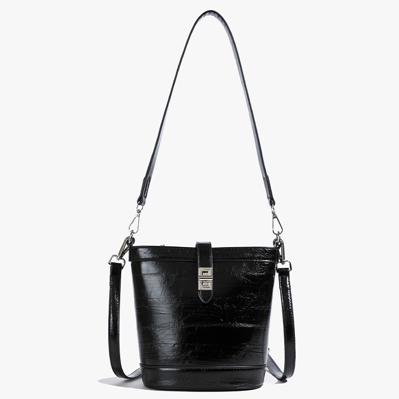 Moda simple bolso de cubo portátil mujer 2025 nuevo estilo versátil retro bolso de hombro casual alta sensación de mochila