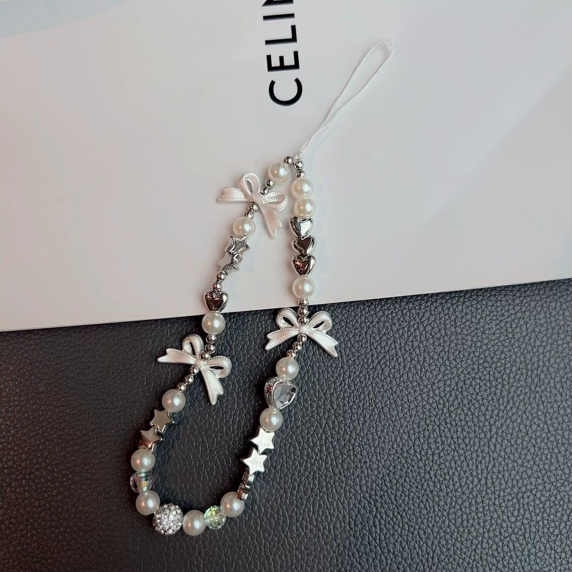 Phone strap beaded keychain, pearl‑bow charm, universal bag/camera accessory, gift‑ready