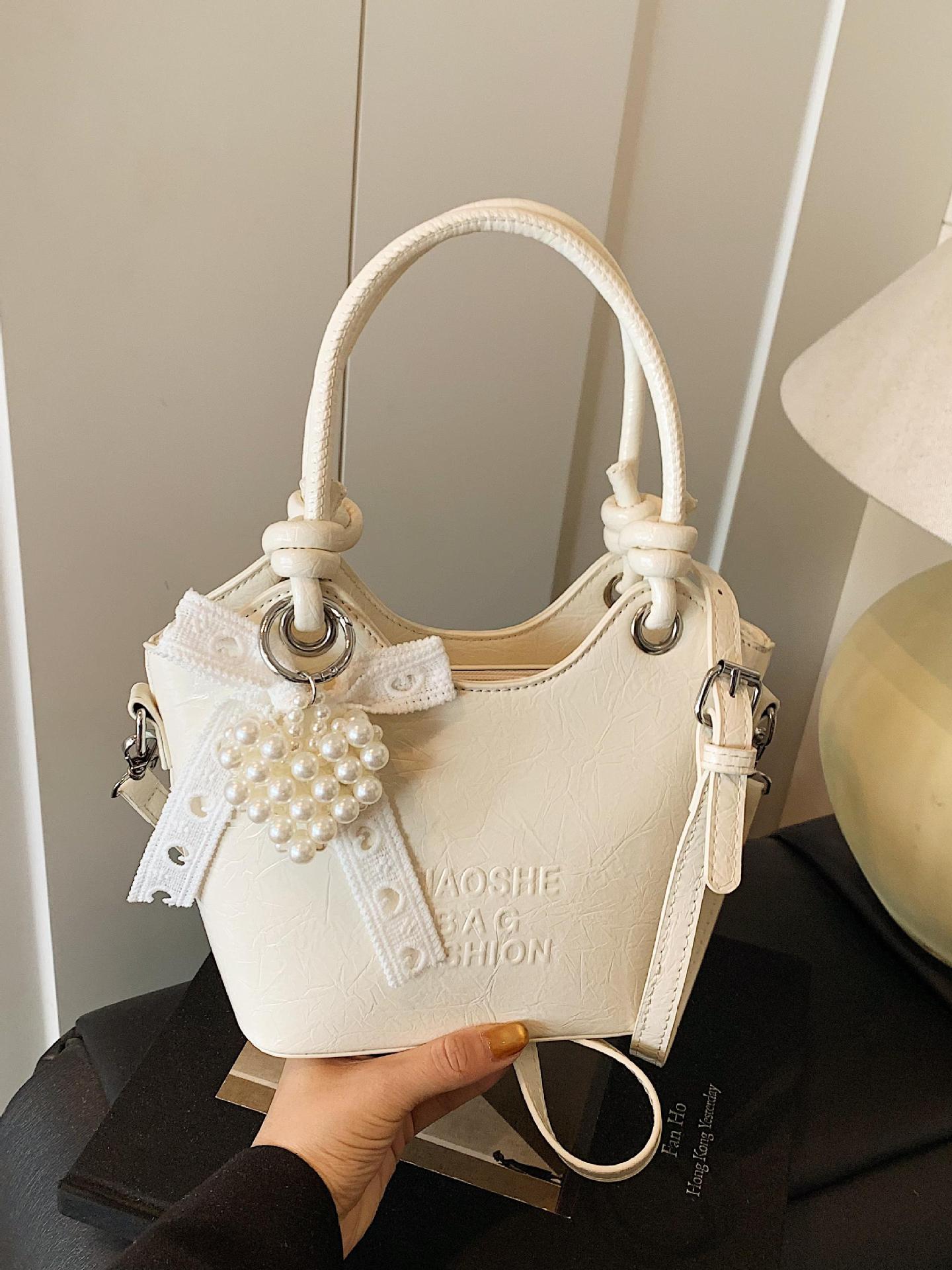Bolso de mano de estilo occidental de ocio para mujer 2025 nuevo producto de moda de cercanías bolso de mensajero de un solo hombro de todo fósforo bolso de cubo de cuero de cera de aceite