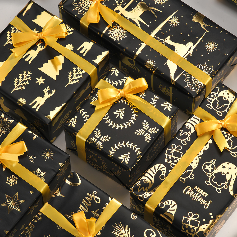 Nuevo papel de regalo de oro negro de Navidad transfronterizo papel de cobre brillante copo de nieve papel de regalo de ciervo de Navidad papel de regalo