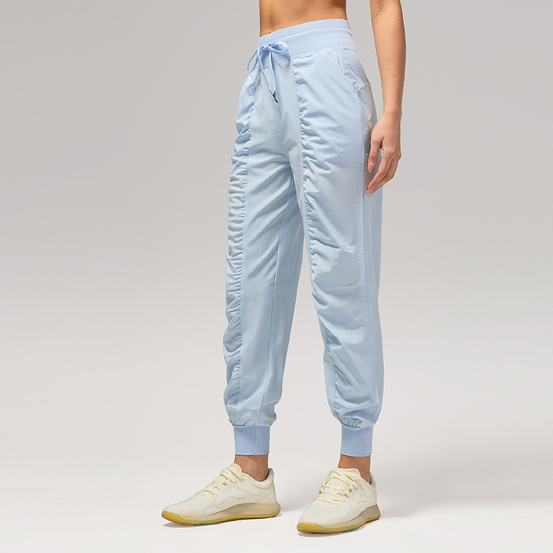 Pantalones deportivos casuales sueltos de mujer plegados para correr pantalones de yoga de nueve puntos de bolsillo secado rápido pantalones de pies transpirables