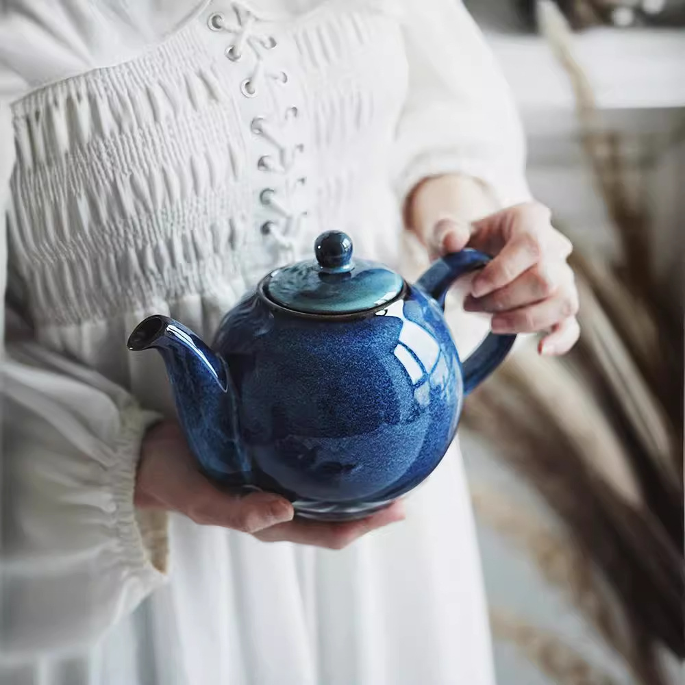 Tetera de cerámica europea creativa tetera de té de la tarde tetera de té de kung fu doméstica tetera de té de alta temperatura tetera de agua redonda de color