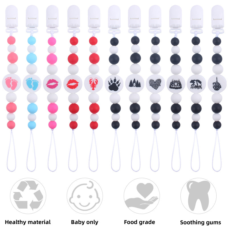 Nuevo bebé suministros de dibujos animados de impresión redonda amor creativo DIY silicona mordedura molar pezón cadena anti-caída