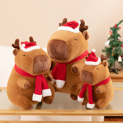 クリスマスカピバラのアイデアカピバラのぬいぐるみぬいぐるみのぬいぐるみ子供が枕を抱いて祝日のプレゼントを飾っています。