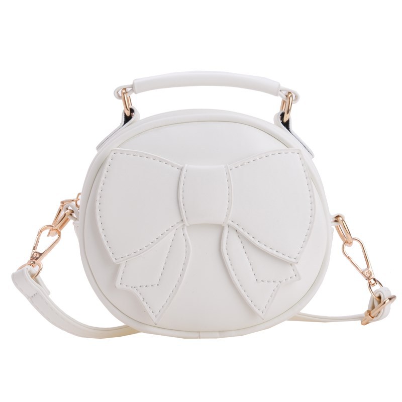 Bolsos para niños mini lindos arcos para hombres y mujeres, bolsos redondos para niños 2025 moda coreana nueva bolsa de cambio para niños