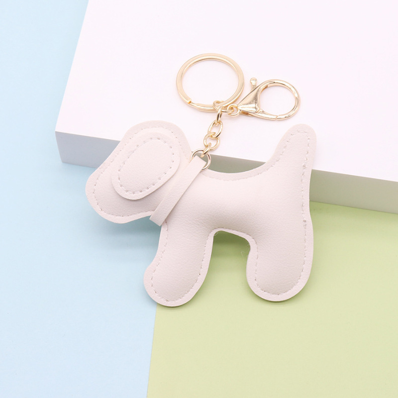 多色の創意的な子犬の鍵は革の掛け物を掛けます。|undefined
