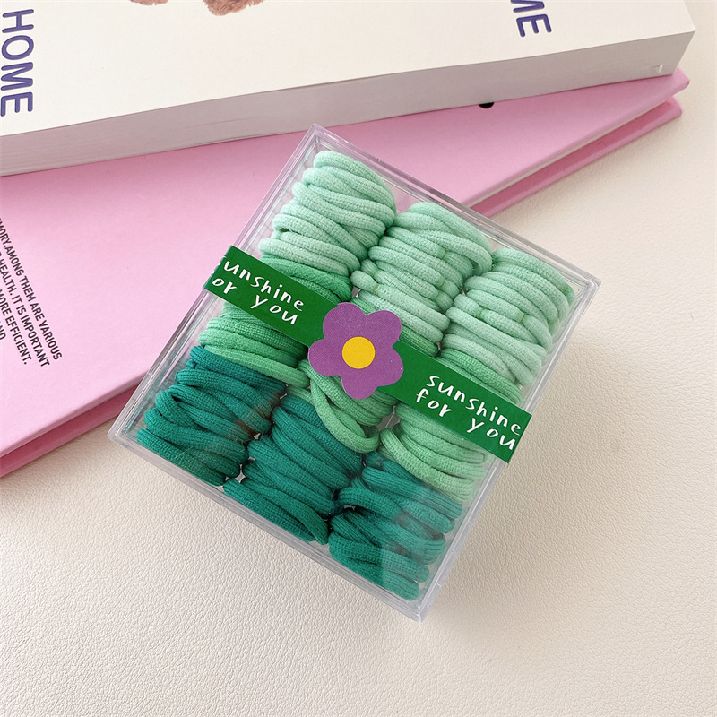 Base de banda de pelo pulgar de los niños base 90 bandas de goma cuerda de pelo para niños color caja de pelo cuerda cabeza accesorios al por mayor