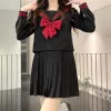 Three long-sleeved black tops + black skirt 42cm + free bow tie