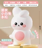 Little white rabbit pressing water gun