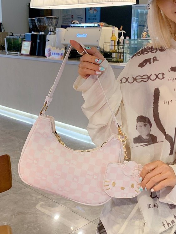 Moda de dibujos animados 2025 nuevo bolso de axilas de gato kt diseño de nicho coreano bolso de media luna de un solo hombro mochila de estudiante