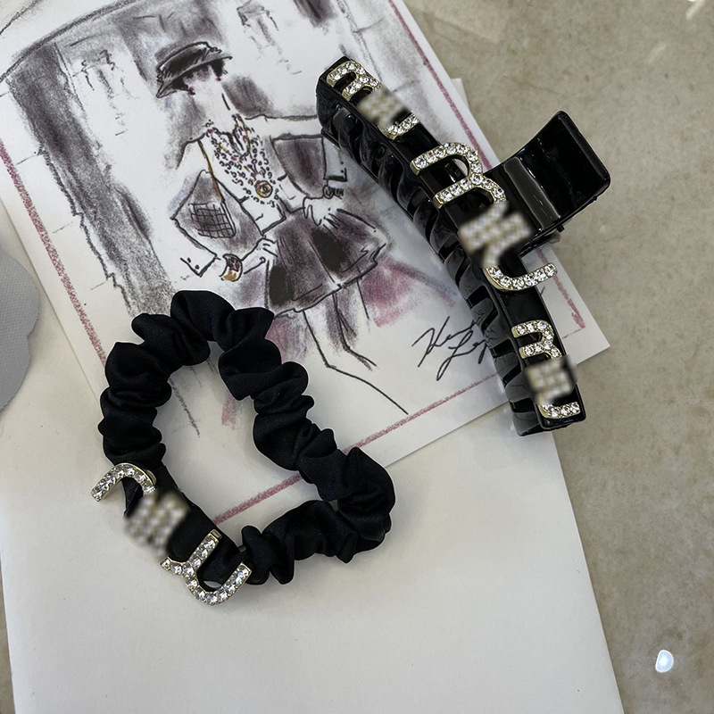 Elegant black hairgrip with letters
