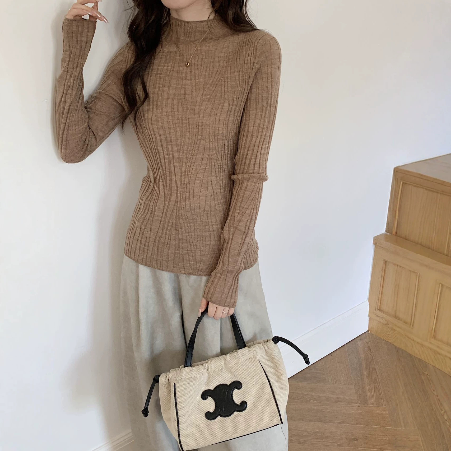 100% Merino fine wool, machine washable, seamless textured long-sleeved, versatile, slim-fitting base layer sweater for spring.