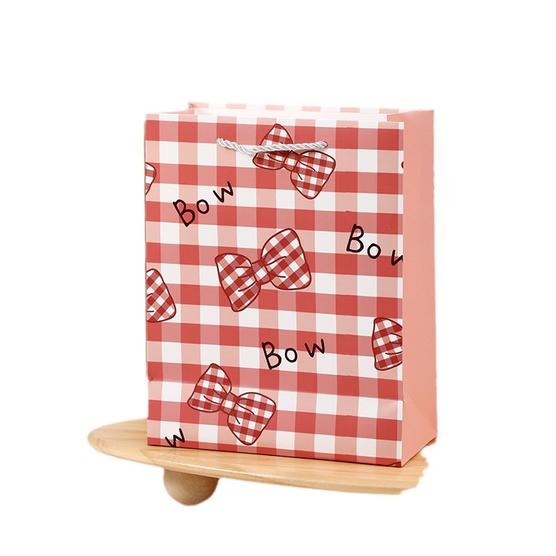 Personalidad de arco de papilla espesa bolsa de regalo de papel blanco regalo de cumpleaños bolsa de papel de embalaje de regalo de fábrica directa