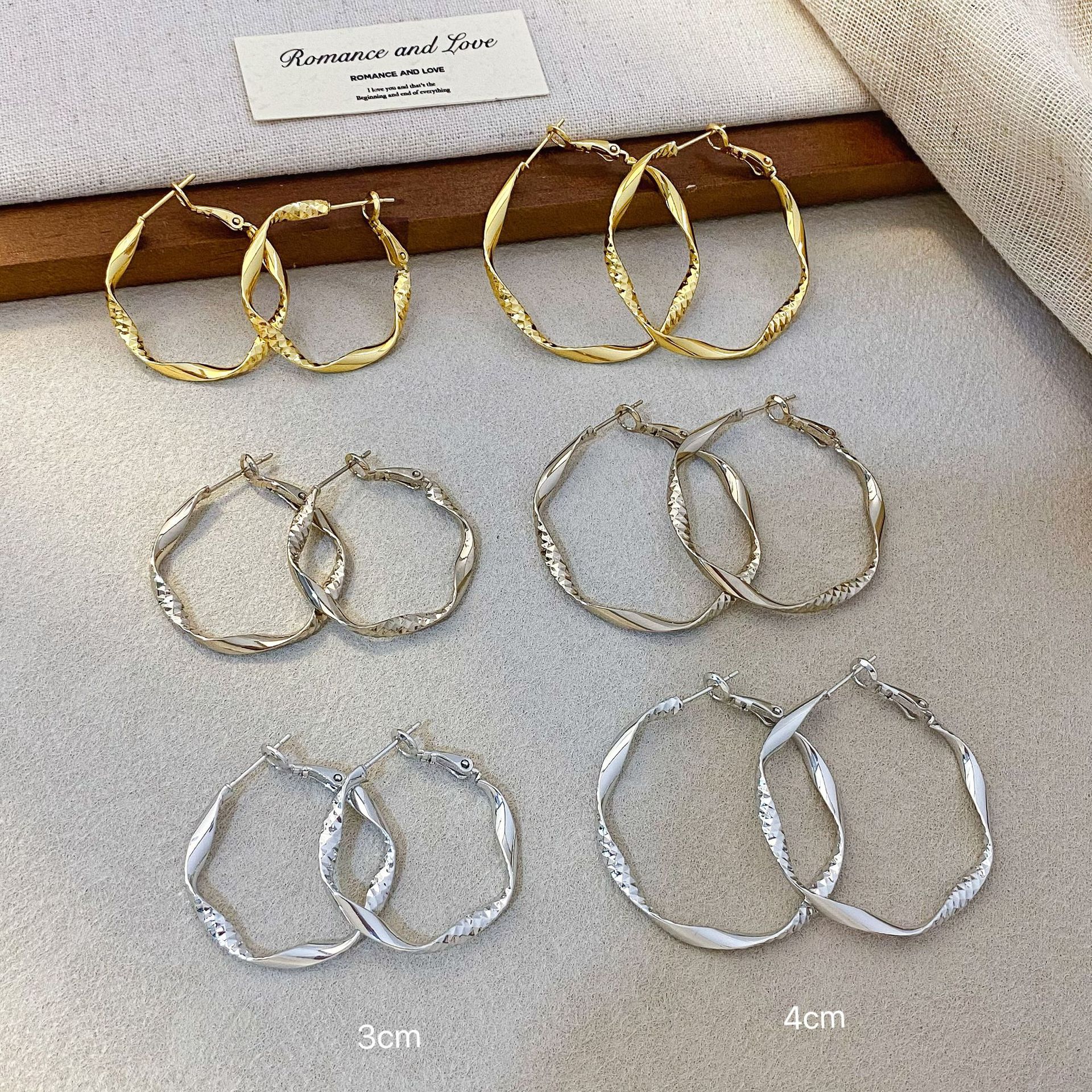 Copper-plated with real gold, featuring a Japanese and Korean Möbius twist pattern, these unique hoop earrings offer a new, high-end, and elegant look for women