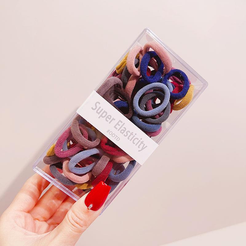 Asequible caja de almacenamiento de Corea del Sur de los niños pequeño tamaño cabeza cuerda bebé toalla anillo no duele pelo cabeza cuerda macaron pelo anillo