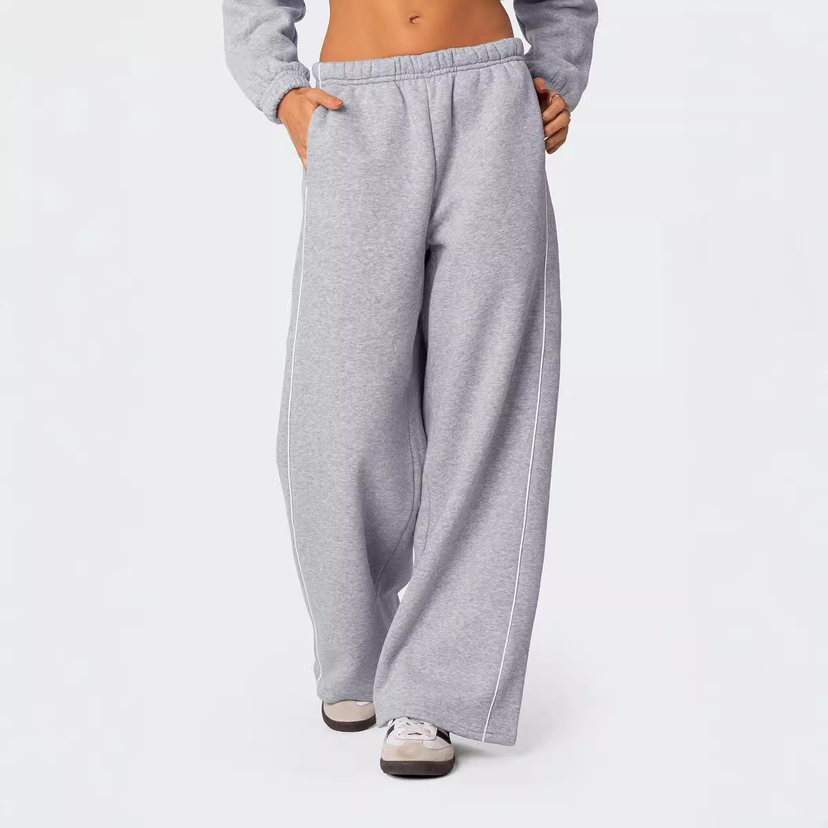 Europa y los Estados Unidos transfronterizos otoño y invierno personalidad callejera mujer blanco contraste rayas laterales casuales cintura elástica pantalones deportivos rectos