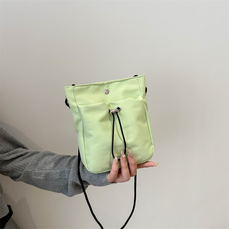 Bolsos de teléfono móvil de viento minimalistas para mujeres japonesas y coreanas bolsos de lona ligeros de cuerda de dibujo mini multifuncional bolsos de cambio de hombro